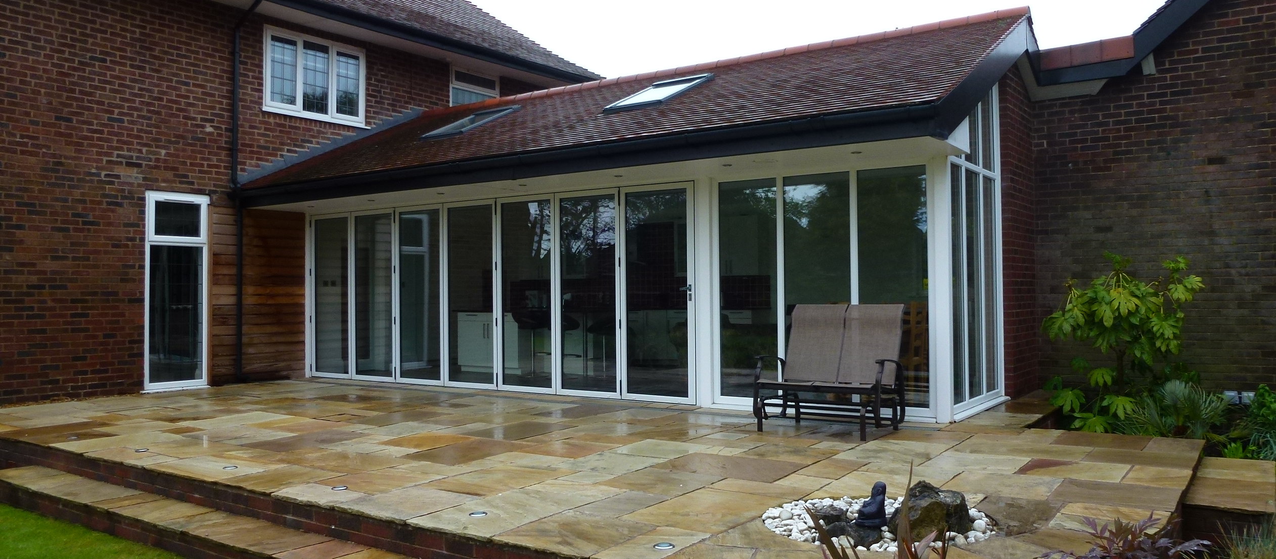 Rear extension with bi-fold doors, skylights and a stepped Indian stone patio