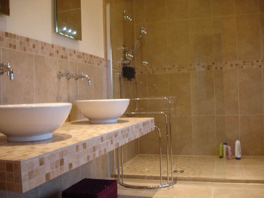 Finished bathroom with vessel basins, mosaic tiling and a walk-in shower